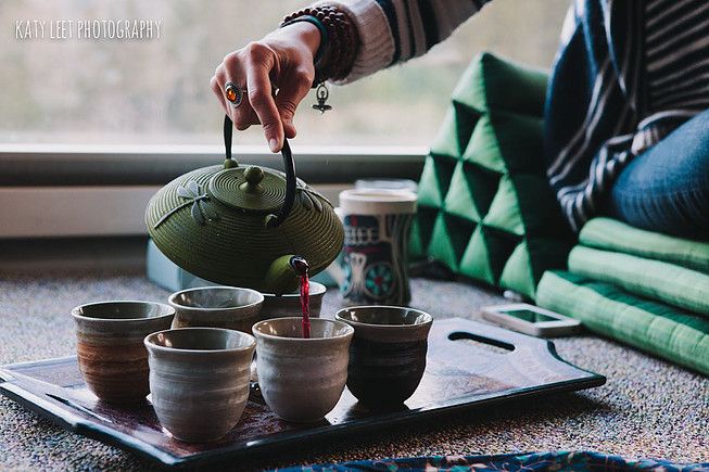 picture of persons arm pouring tea from clay pot into several cups.  sacred tea ceremony north jersey portpartum sealing ceremony hackettstown
