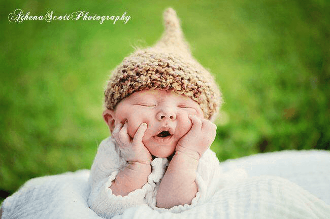 new jersey doula services baby in a field with acorn hat on