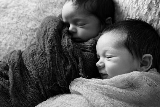 twin babies wrapped in snuggly blanket, one sleeping, the other barely awake, new jersey birth doula, hackettstown birth doula, new jersey natural birth classes and doula services